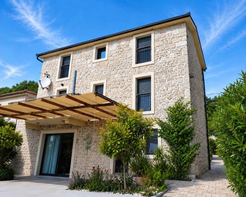 a large brick building with a wooden awning at Stone Luxury Villa Imota in Imotski