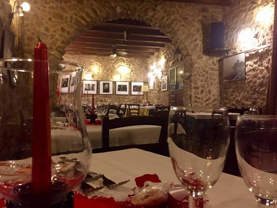 two wine glasses sitting on a table in a restaurant at il portico dei normanni in Butera