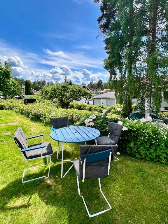 a table and chairs sitting in the grass at Nordic Quiet Stay in Falun