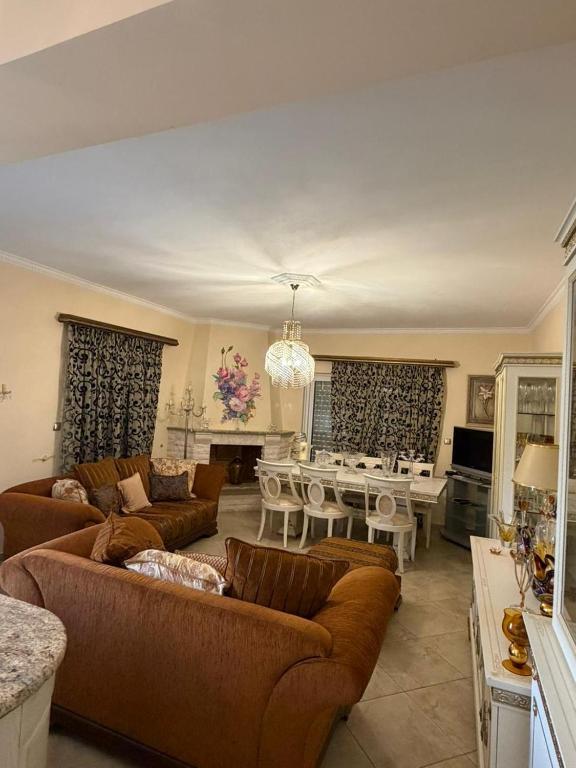 a large living room with couches and a dining room at Villa Kastri in Igoumenitsa