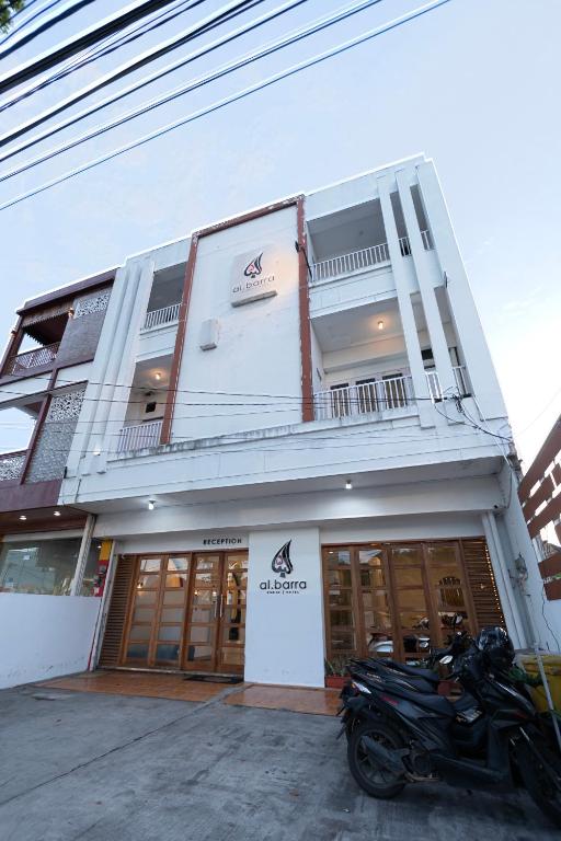 a motorcycle parked in front of a building at Al Barra Syariah Hotel in Bukittinggi