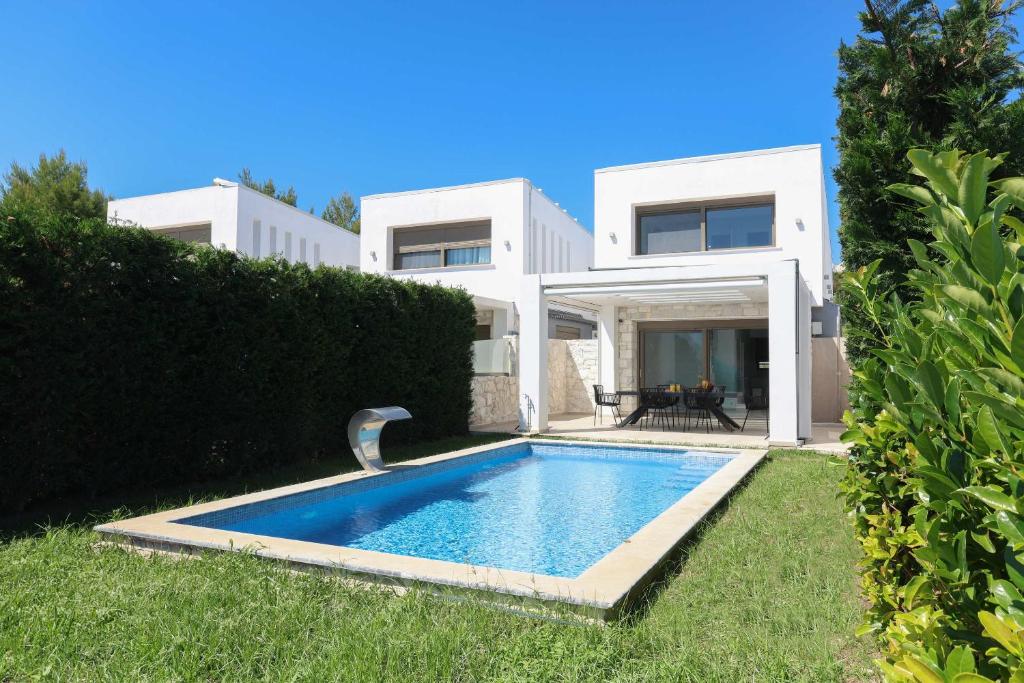 a house with a swimming pool in the yard at Villa Mare 3 - Private Pool, Sea View in Hanioti