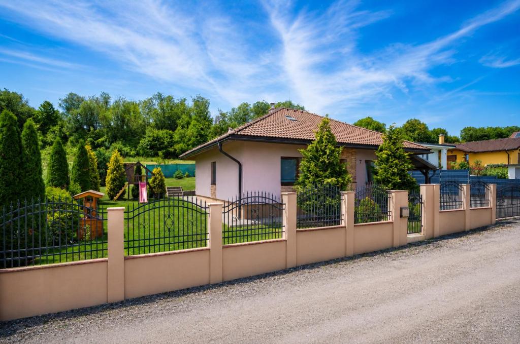 a fence in front of a house at Family Bungalov Banská Bystrica in Banská Bystrica