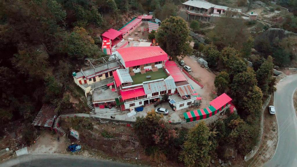an aerial view of a large house with a red roof at Sherjang Events in Munsyari