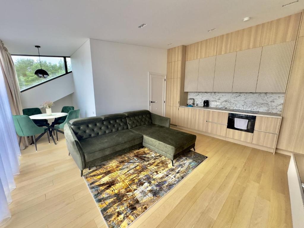 a living room with a couch and a table at V7 Apartamentai Nidoje in Nida