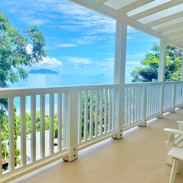 a white porch with a view of the ocean at Bord Mer House in Glacis