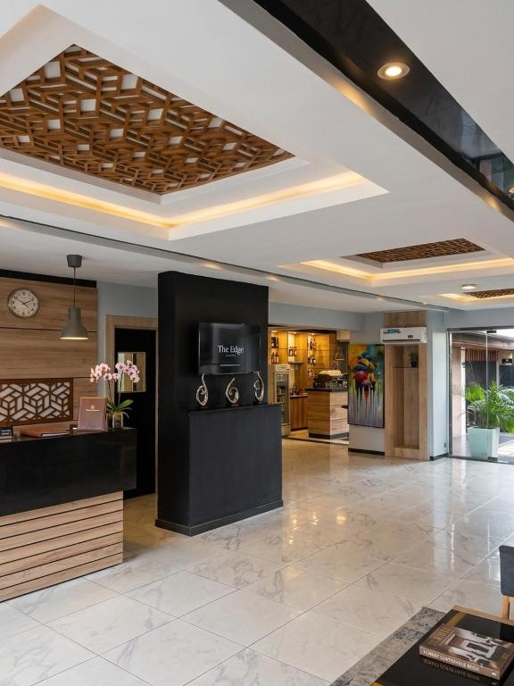 a lobby of a hotel with a reception desk at Edge ONE Resort in Gwarinpa