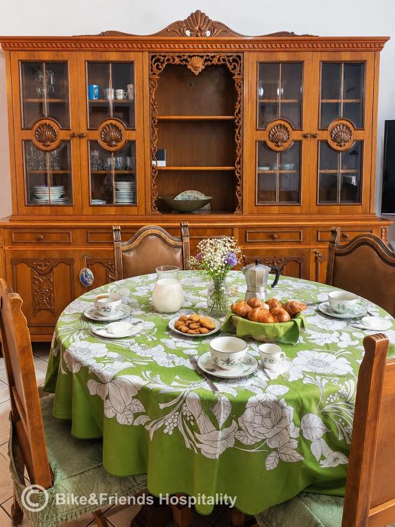 a table with a green and white table cloth at CASA BETTI in Pesaro