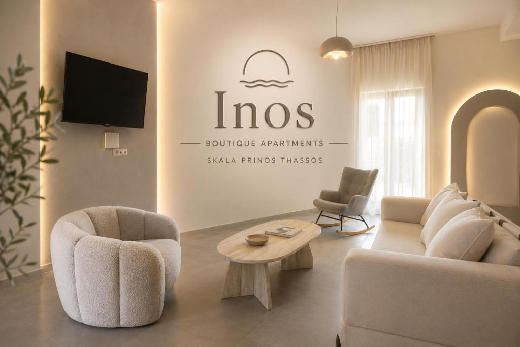 a living room with a couch and chairs and a tv at Inos Boutique Apartments in Skala Prinou