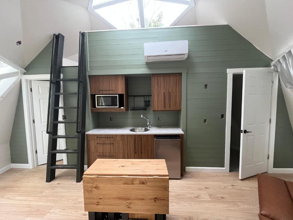 a room with a kitchen with a loft at Blue Bayou Dome Village in Dingwall