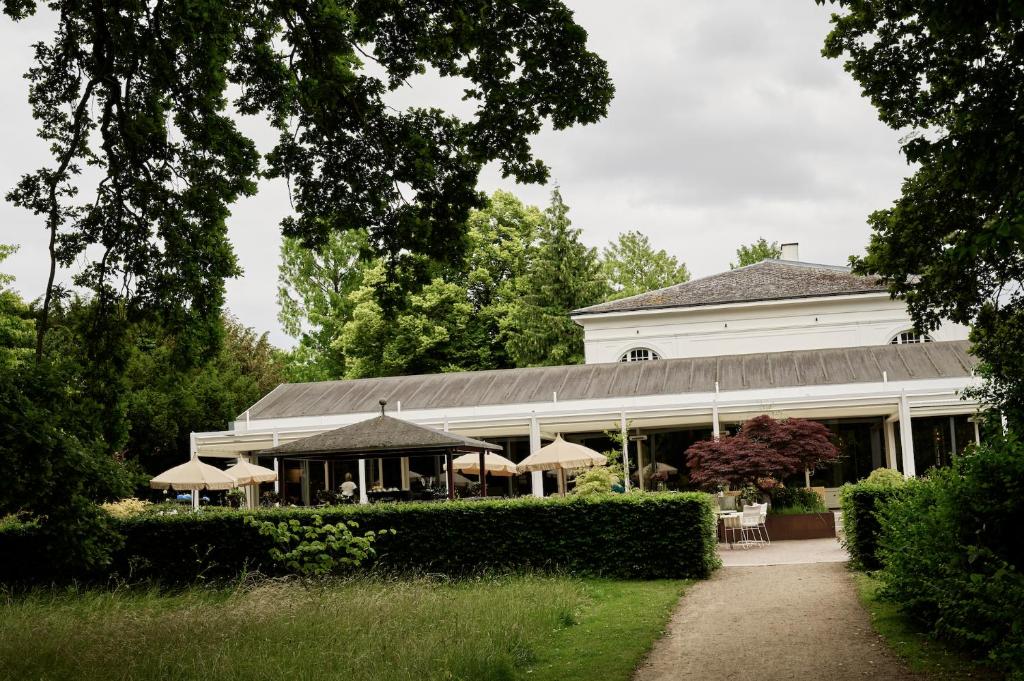 a white building with umbrellas in front of it at Josty Frederiksberg in Copenhagen
