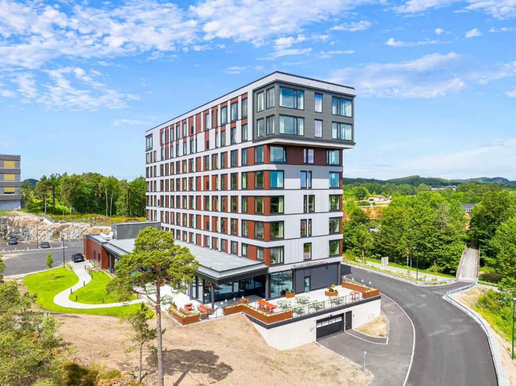 an apartment building with a view of a street at Comfort Hotel Grimstad in Grimstad