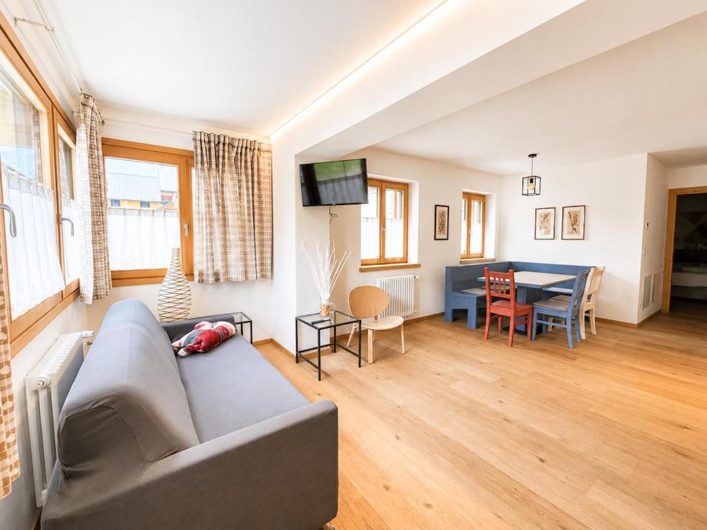 a living room with a couch and a table at Blu Betulle, Free Park and Ski room in Camporosso in Valcanale