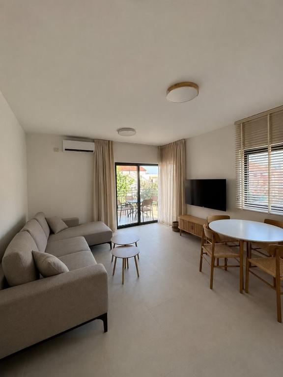 a living room with a couch and a table at Stan 11 in Đenovići