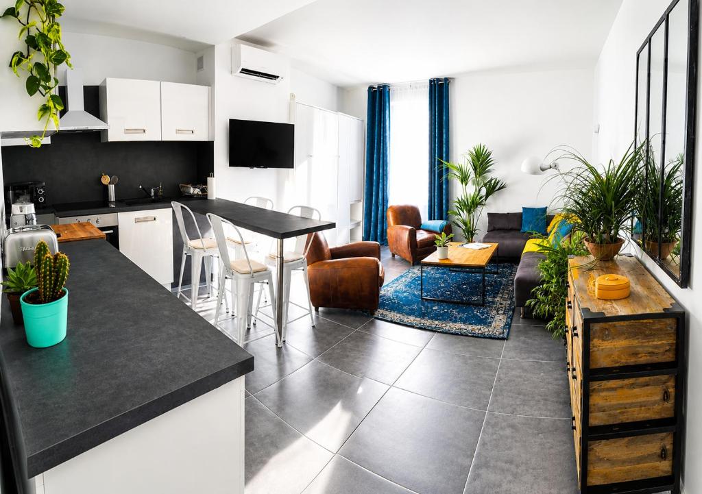 a kitchen and living room with a table and chairs at Beautifully Bright Apartment in Old Town Saint-Tropez in Saint-Tropez
