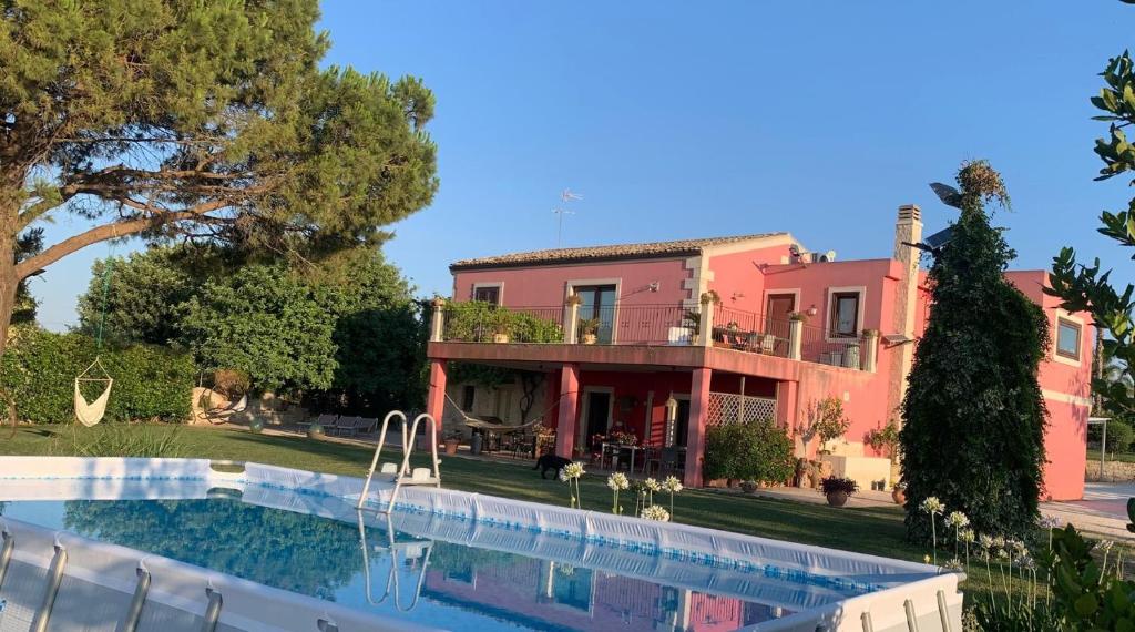 a house with a swimming pool in front of it at Richiami di Sicilia in Modica