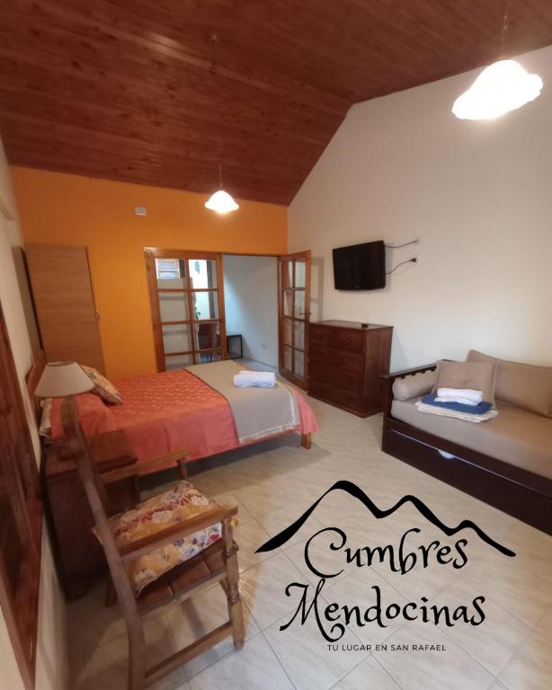 a bedroom with a bed and a couch and a tv at Hospedaje Cumbres Mendocinas - El Diamante in San Rafael