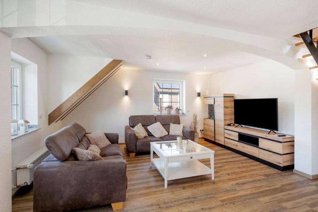 a living room with a couch and a tv at Ferienwohnung "Am Waldrand" in Bottrop