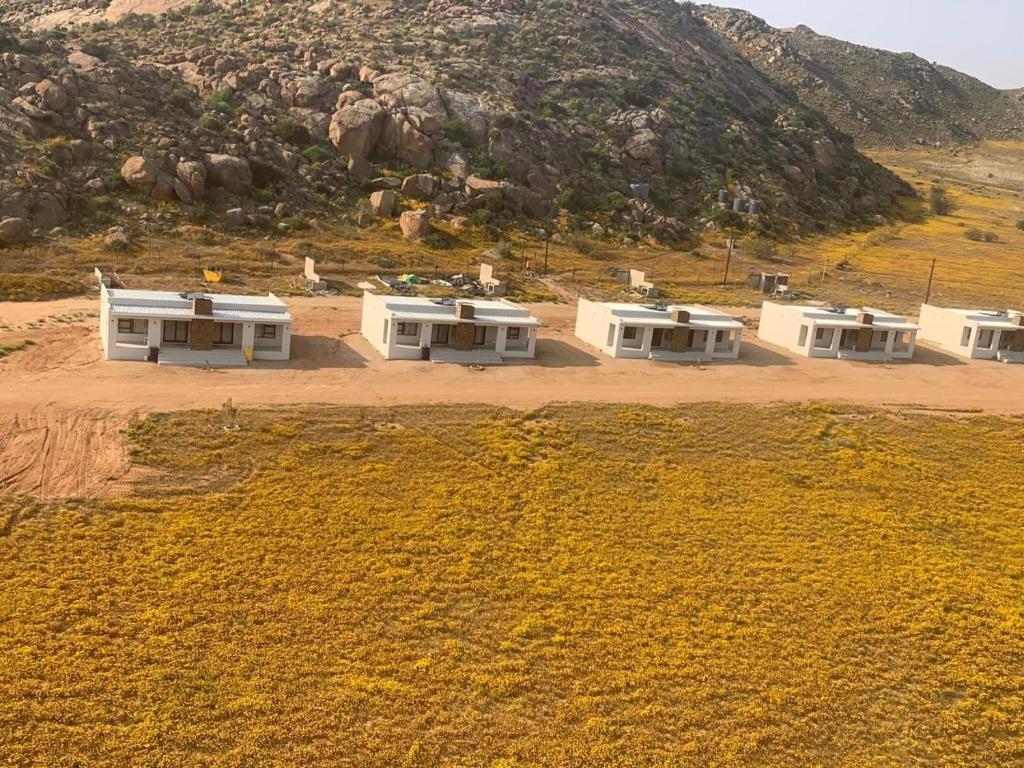 an aerial view of three houses in a field at Springbok Guest Farm in Springbok