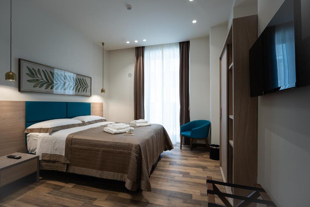 a hotel room with a bed and a television at I Segreti del Chiostro - Le Dimore in Palermo