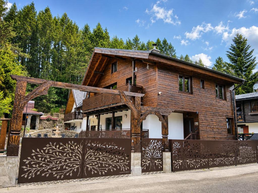 a wooden house with a gate in front of it at Anna Sela in Vrbov