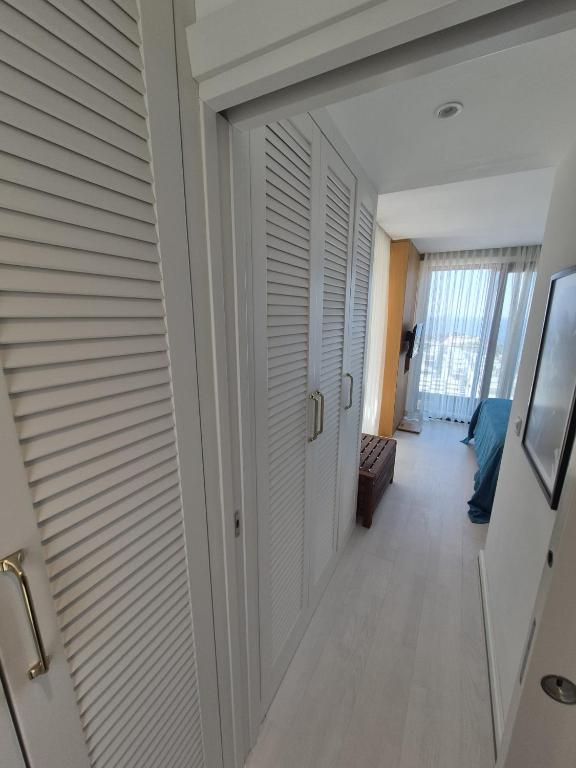 a hallway with white closet doors in a room at Helis Bodrum Residence in Milas