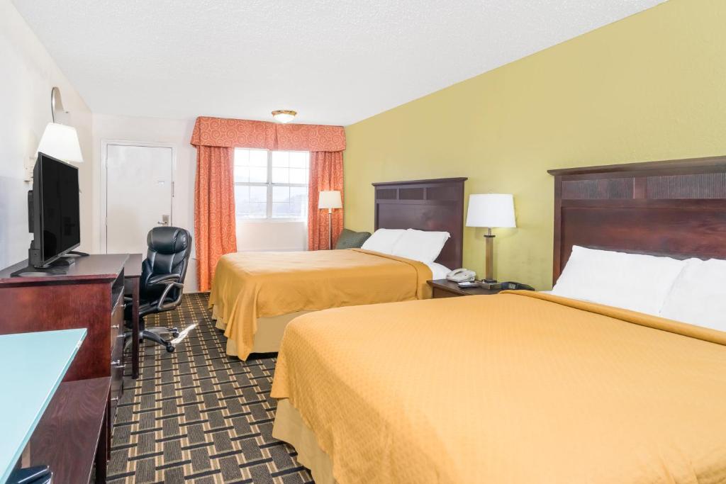 a hotel room with two beds and a flat screen tv at Knights Inn Chattanooga in Chattanooga