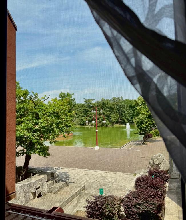 a view from a window of a park with a fountain at Vista Lago in Basiglio