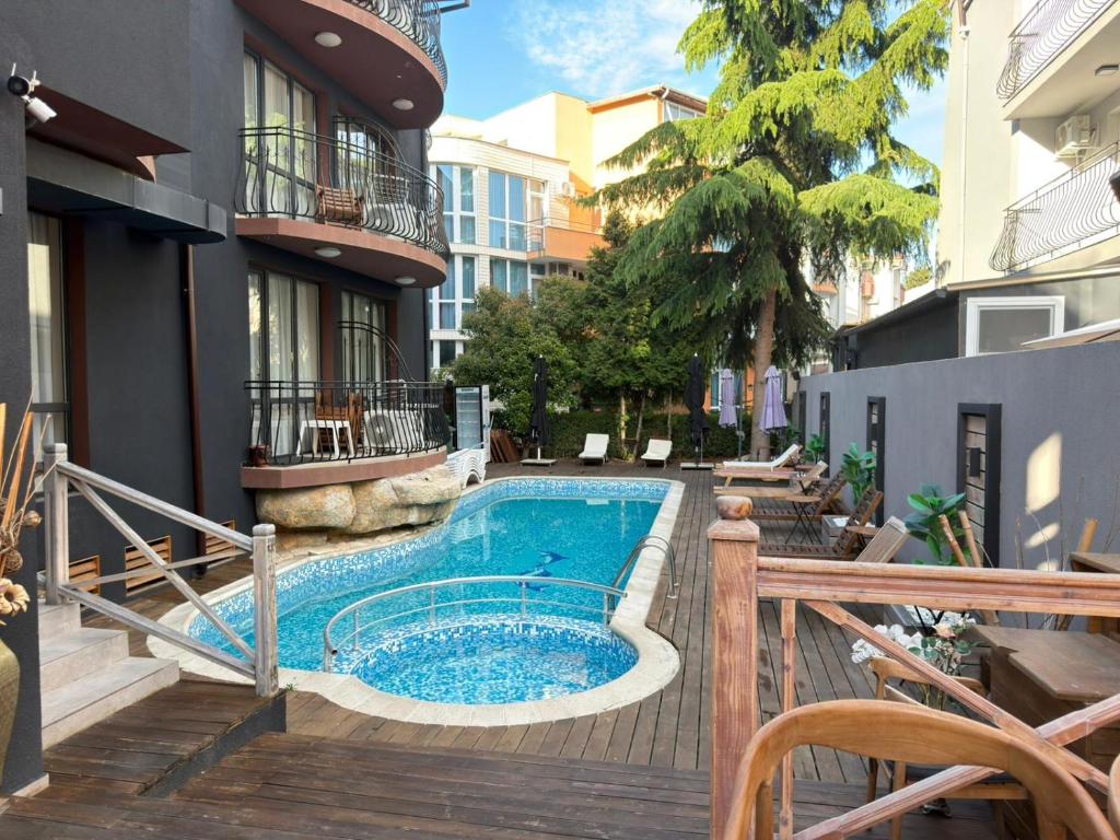 a swimming pool on a deck next to a building at Adeti Residence in Nesebar