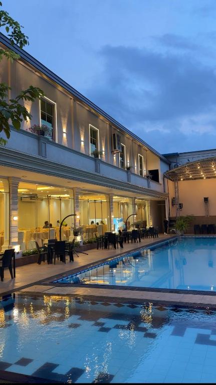 a hotel with a swimming pool in front of a building at The Lamendriea Hotel in Kalagedihena