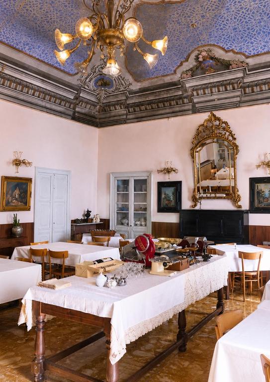a dining room with white tables and a ceiling at Albergo dell'Angelo in Pieve di Teco