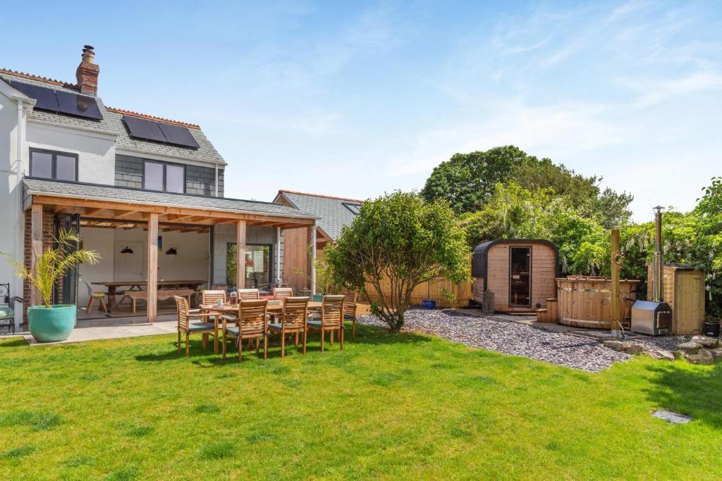 a patio with a table and chairs in a yard at 4 Bed in Bugle oc-f34175 in Penwithick