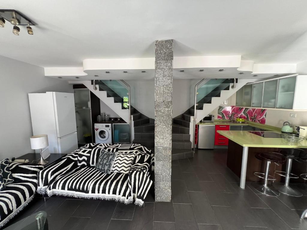 a living room with zebra print furniture and a staircase at Playmar6970 in Maspalomas