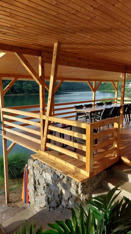 a wooden gazebo with a table under it at Cabana 325 in Cinciş