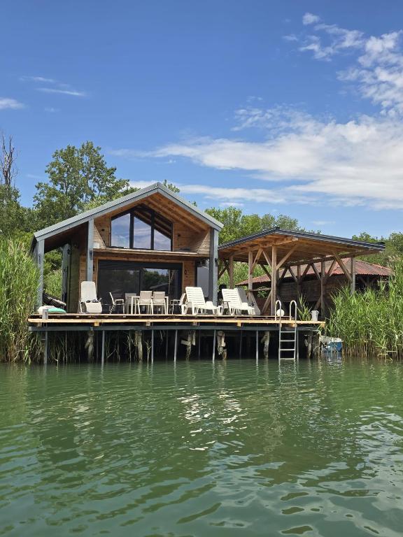 a house on a dock on a body of water at CabinAtRiver Ada Bojana in Ulcinj
