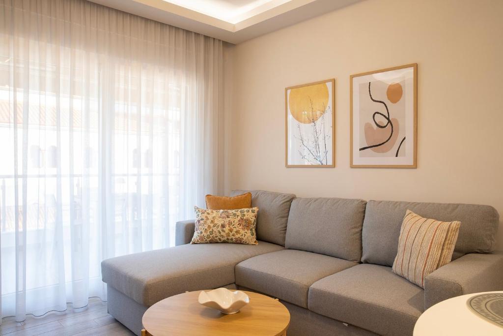 a living room with a couch and a table at Boheme Apartment in Leptokarya