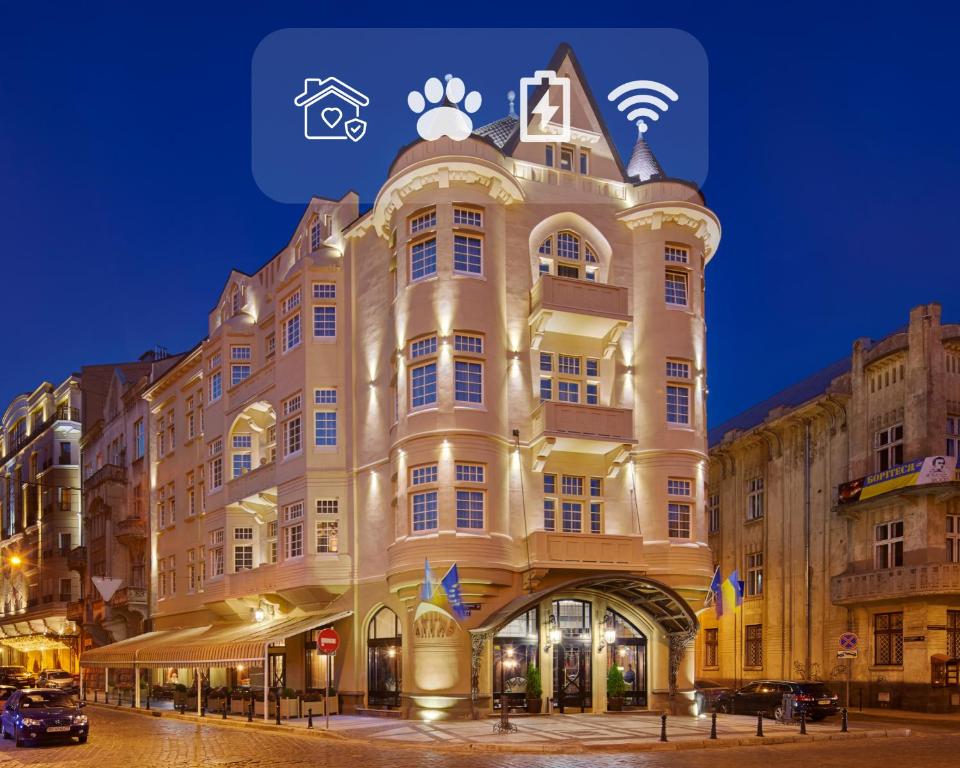 a large building with a sign on top of it at Hotel Atlas Deluxe in Lviv