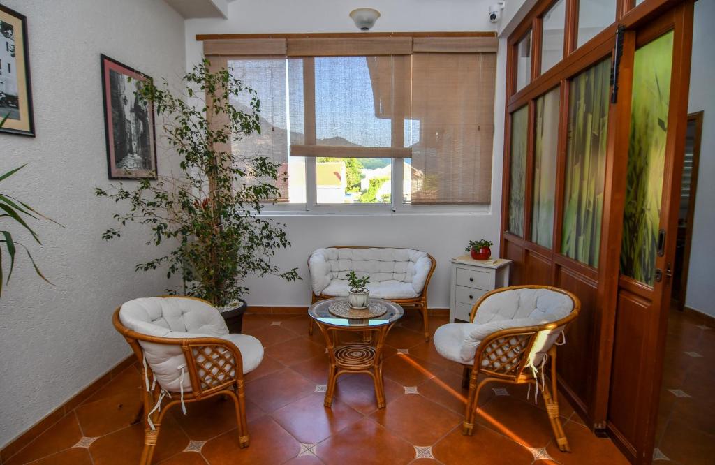a living room with chairs and a table and a window at Guest house Šebelj in Budva