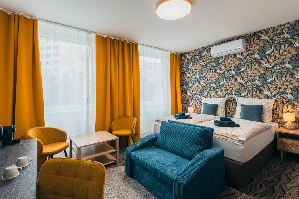 a hotel room with a bed and a chair at Hotel Mauricius in Příbram