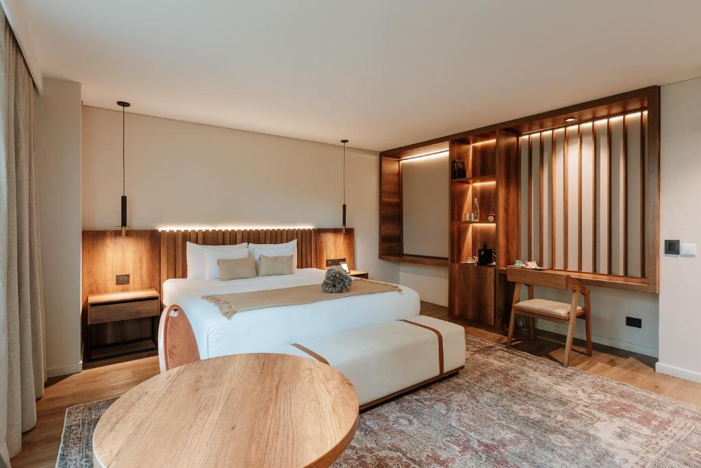 a bedroom with a large bed and a table at 1616 Hotel in Medellín