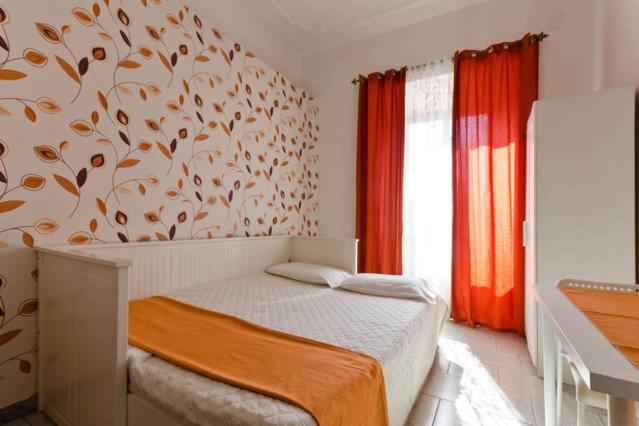 a bedroom with a bed with a tree mural on the wall at Hostel Castello Maggiore in Rome