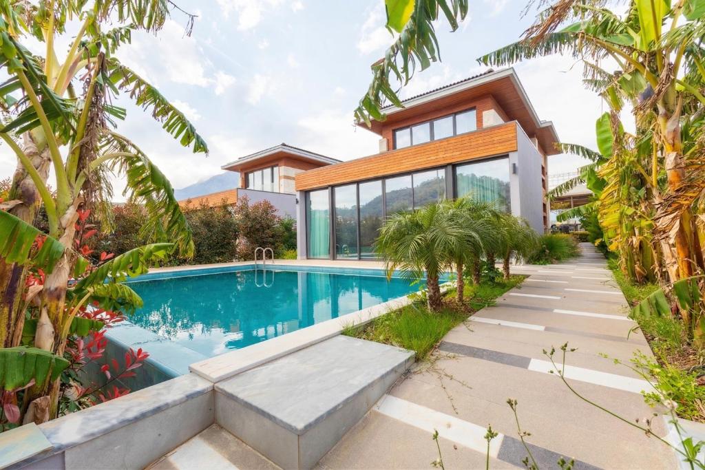 a home with a swimming pool and a house at Leaf Villa Terra in Antalya