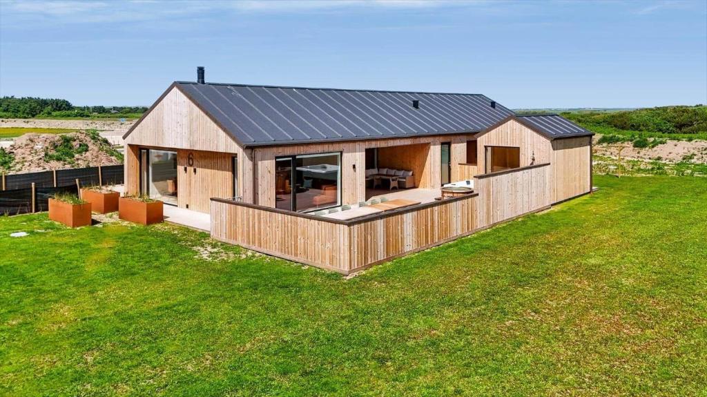 an overhead view of a wooden house in a field at 839-Harboore-Strandvaenget-6 in Harboør