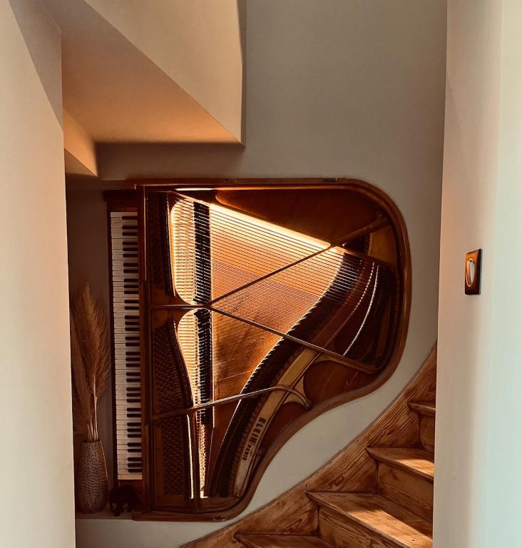 a wooden stairwell with a spiral staircase in a house at Le Piano dans la Vigne in Barr