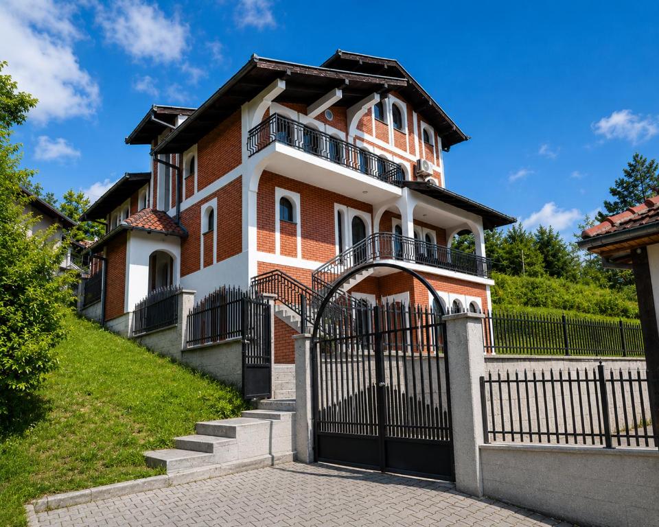 a house with a gate in front of it at Dea Apartments - Peja in Peje