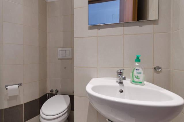 a bathroom with a sink and a toilet and a window at Hostel Castello Maggiore in Rome
