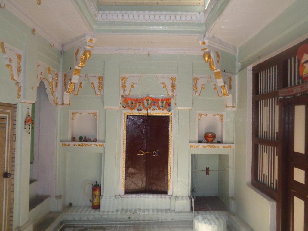 an ornate room with a door and a window at Feel Aesthetic Kashi Home Stay in Varanasi