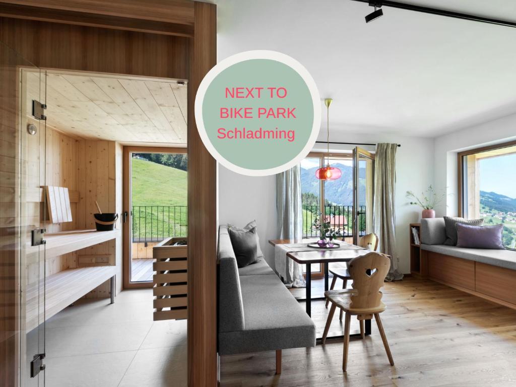 a living room with a couch and a table at Holzhackerin - the charming Haus am Berg in Schladming