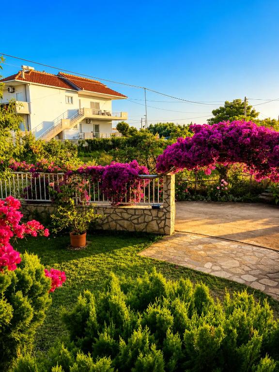 a garden with flowers in front of a building at Demetra in Mytikas