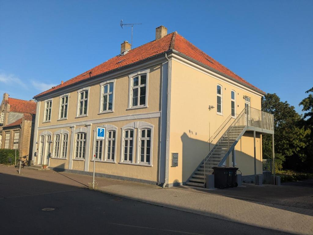a large white building with a staircase in front of it at Stubbekøbing City View Stopover in Stubbekøbing